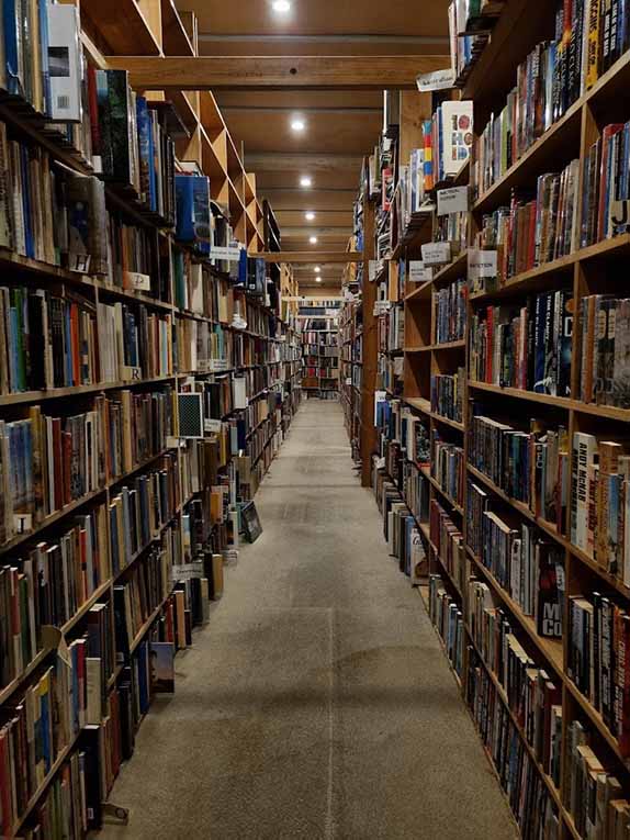 long hallway between bookshelves